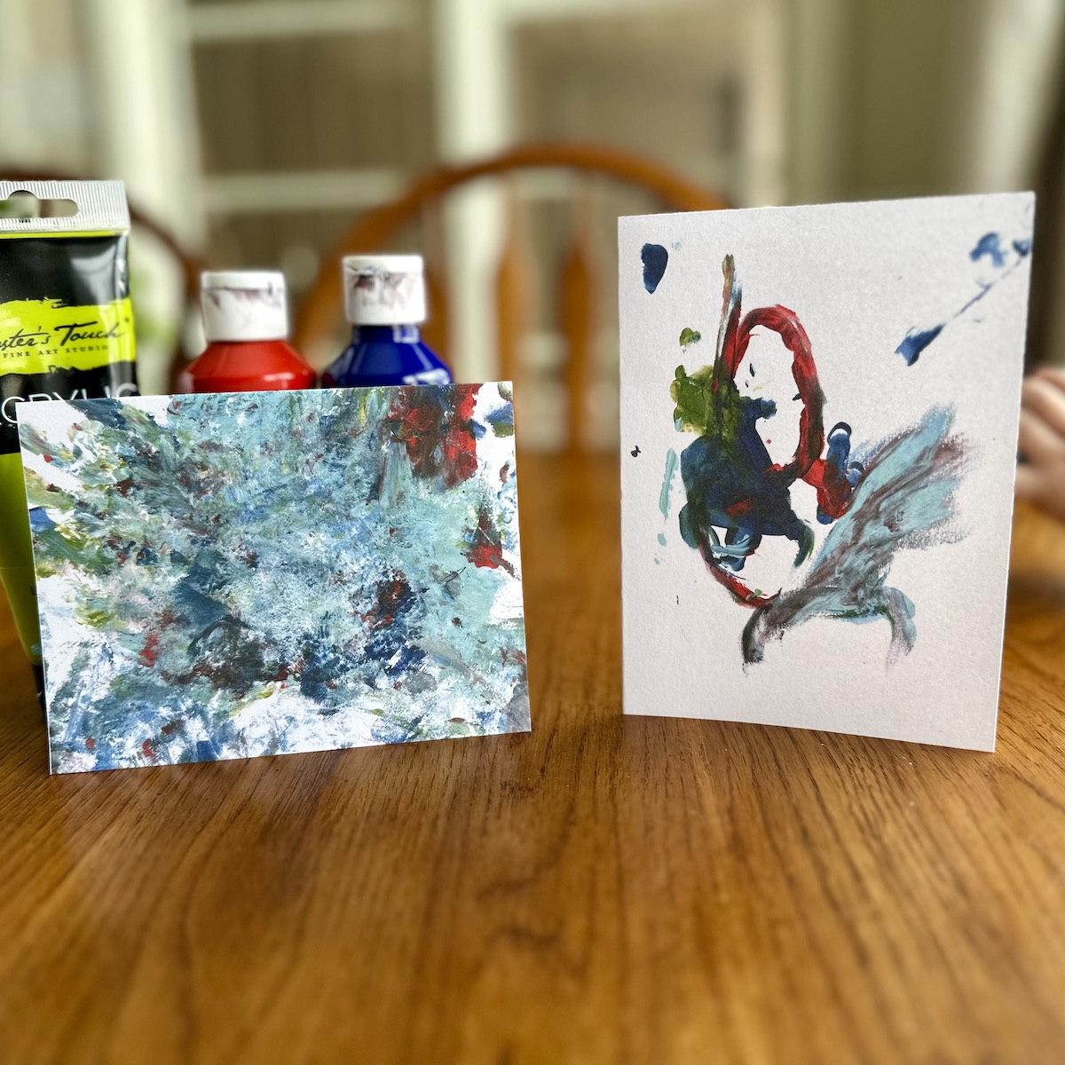 Greeting card made by a 2-year-old with blue, yellow, red, and teal paint